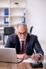 Fototapeta premium Old male employee and too much work in the office