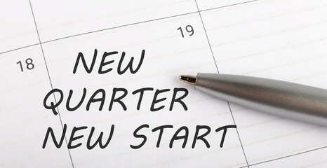 Text NEW QUARTER NEW START on calendar planner to remind you an important appointment with a pen on isolated white background.