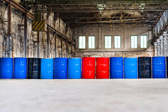 Multicolored barrels at the factory standing in a row