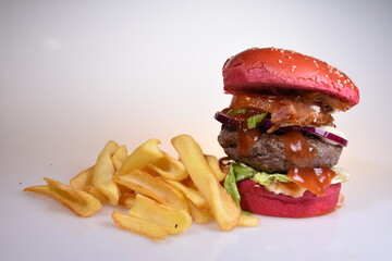 hamburger with red bread and fresh vegetables  and french fries