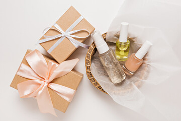 Organic cosmetics and gifts for the holiday. Flat lay, top view clear glass pump bottle, brush jar, moisturizing serum jar in a paper basket on a white background. Natural cosmetics SPA