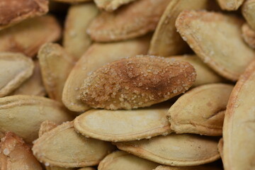 Whole roasted salted pumpkin seeds, macro shot
