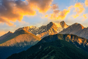 Beautiful mountain and colorful clouds natural landscape at sunset in Xinjiang,China.