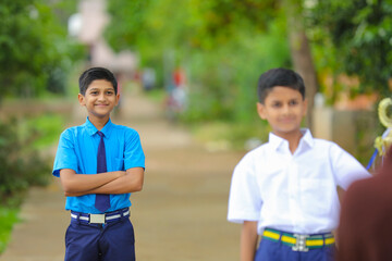 Indian little school boy giving expression over nature background.