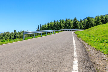Country road and green forest with mountain natural landscape.