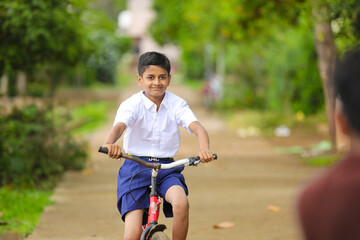 indian / Asian little boy enjoy cycle riding