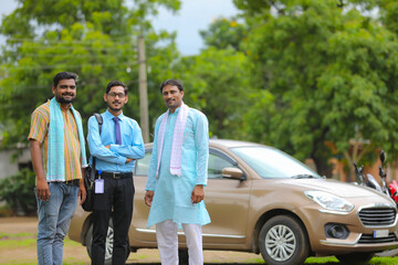 Vehicle loan concept: Young indian banker and farmers standing with new car