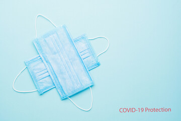 Blue Medical Disposable Face Mask with covid-19 printed on it. Coronavirus pneumonia gets official name from WHO: COVID-19. Disposable breath filter face mask with earloop.