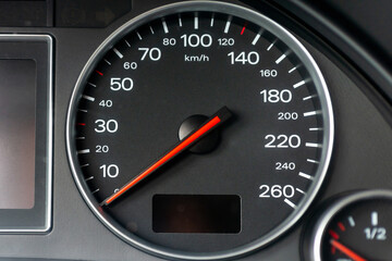 Fototapeta premium Speedometer in a car. Car dashboard. Dashboard details with indication lamps.Car instrument panel. Dashboard with speedometer.Car detailing. Modern interior.Closeup.Copy space.