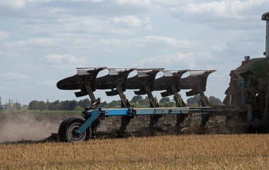 Agricultural tractor plowing a field before sowing