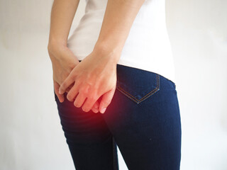 Hemorrhoids in woman and hand holding her bottom on white background for health care concept.