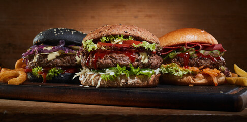 Delicious burgers on wooden table