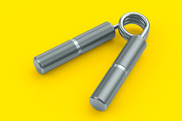 Iron hand expander or resistance band isolated on yellow background.