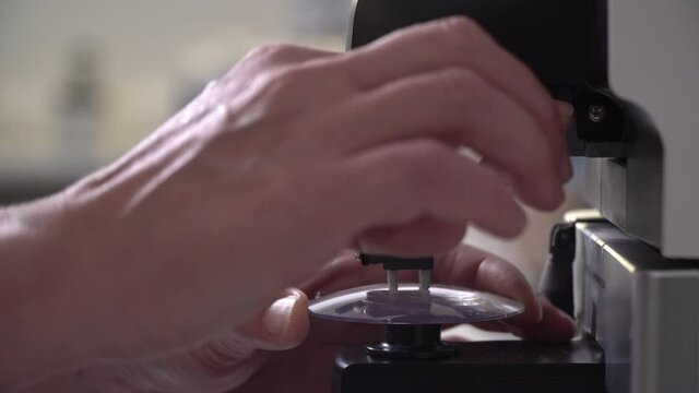 An optometrist makes eyeglass lenses in a laboratory. The science of optometry