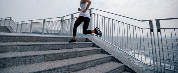 Fitness sports woman runner running on seaside trail