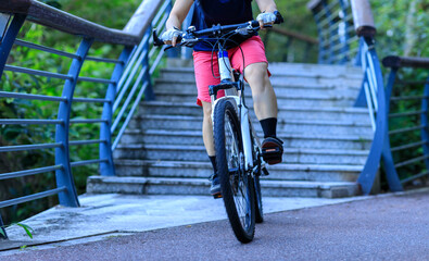 Woman freerider riding down stairs. Sports extreme and active lifestyle