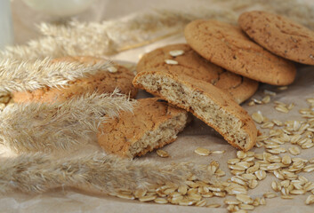 oatmeal cookies and oats on a brown background