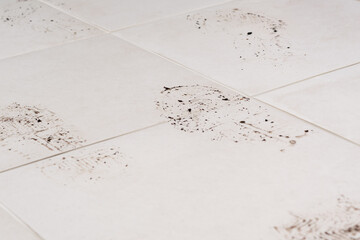 footprints of the sole of shoes on the floor of ceramic tiles, close-up