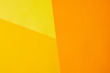 Color papers geometry flat composition background with yellow orange tones. Trendy colors.