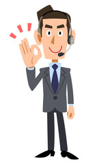 手でOKマークを作るヘッドセットを装着した男性オペレーター
