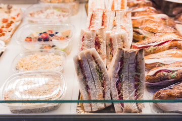 croissant stuffed with tuna lettuce and tomato on display for sale