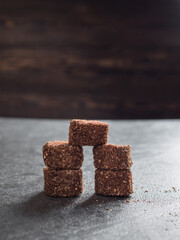 Brown Turkish delight with cocoa on a gray background. Vertically