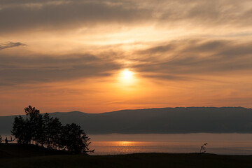 Fototapeta na wymiar golden misty sunset, beautiful yellow evening landscape on the sea