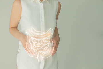 Woman in white clothes holding virtual intestine in hand. Handrawn human organ, detox and healthcare, healthcare hospital service concept stock photo - obrazy, fototapety, plakaty