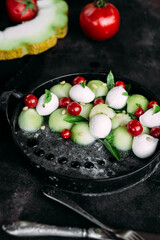 Caprese salad with melon, mozzarella and balsamic sauce. Food styling
