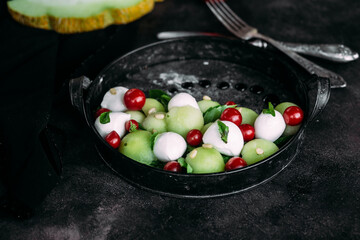 Caprese salad with melon, mozzarella and balsamic sauce. Food styling