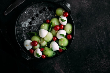 Caprese salad with melon, mozzarella and balsamic sauce. Food styling