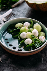 Caprese salad with melon, mozzarella and balsamic sauce. Food styling