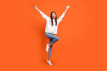 Full length body size view of attractive cheerful carefreee girl dancing having fun isolated over bright orange color background