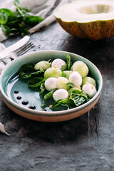 Caprese salad with melon, mozzarella and balsamic sauce. Food styling