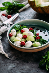 Caprese salad with melon, mozzarella and balsamic sauce. Food styling