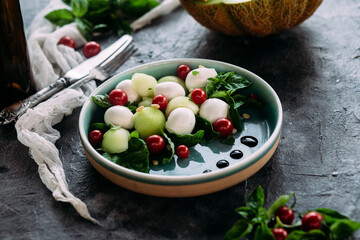 Caprese salad with melon, mozzarella and balsamic sauce. Food styling