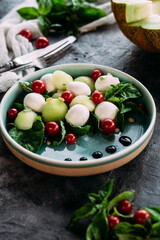 Caprese salad with melon, mozzarella and balsamic sauce. Food styling