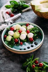Caprese salad with melon, mozzarella and balsamic sauce. Food styling