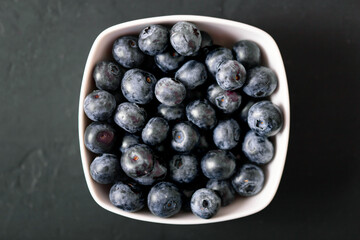 Fresh juicy blackberries on black background.  Summer berries.