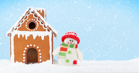Christmas greeting card with gingerbread house and snowman