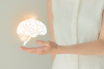 Woman in white clothes holding virtual brain in hand. Handrawn human organ, detox and healthcare,...
