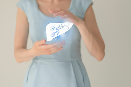 Woman in blue clothes holding virtual gall bladder in hand. Handrawn human organ, detox and healthcare, healthcare hospital service concept stock photo