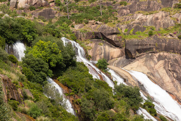 Water cascading over a small lake