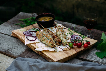 Lula kebab on pita bread with vegetables
