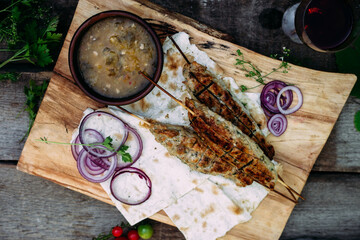 Lula kebab on pita bread with vegetables