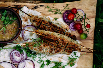 Lula kebab on pita bread with vegetables