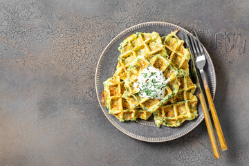 Homemade zucchini waffles in a plate on a culinary background top view from the copyspace
