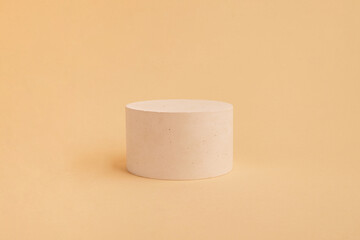 Сoncrete round cylinder shape on beige background. Empty showcase for product presentation. eco style and minimalism. 