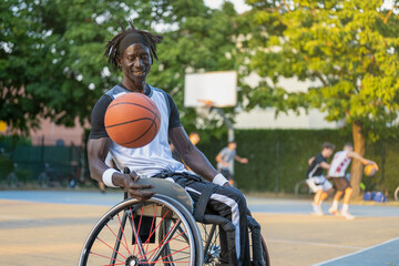 African man with a disability caused by polio playing basketball, champion athlete having disability in a wheelchair, concept of determination and mental toughness - obrazy, fototapety, plakaty