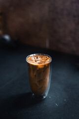 Close-up of iced coffee served on black table at cafe​